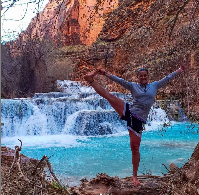 Elly in a standing yoga pose in front of turquoise waterfalls at Havasupai